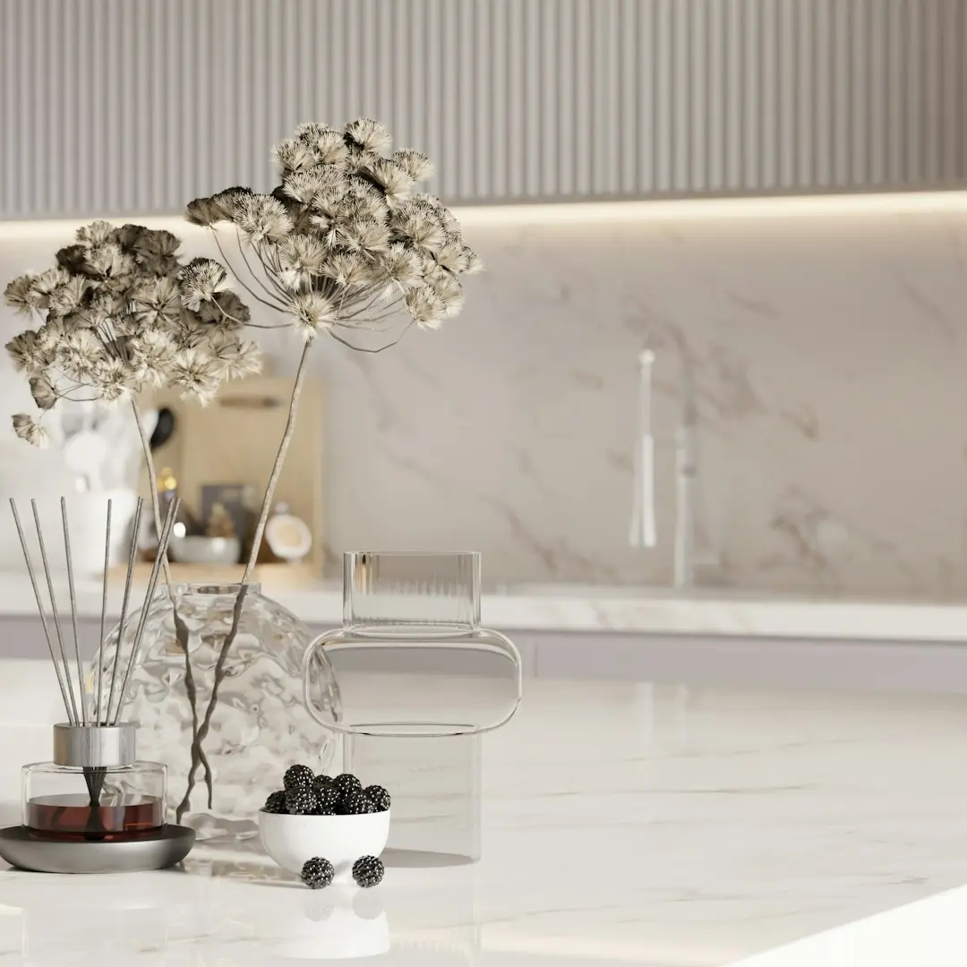 Dried flowers and berries on a marble countertop.