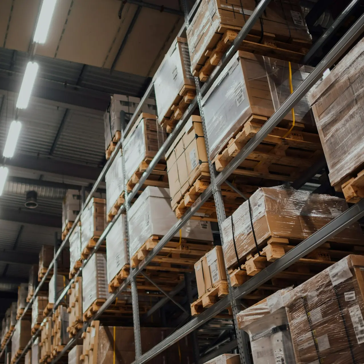 brown cardboard boxes on white metal rack